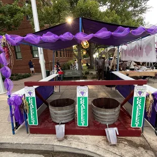 a stand with barrels and banners