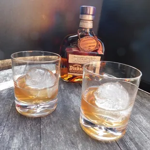 two glasses of wine on a barrel