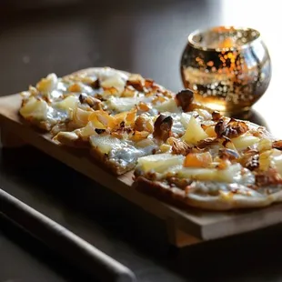 pear and gorgonzola flatbread with mozzarella, caramelized onions, crushed walnuts and honey drizzle