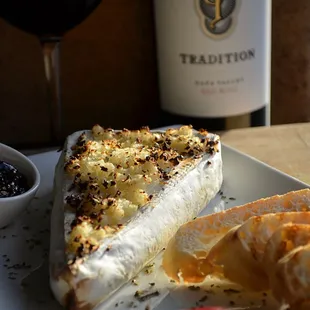 Warm Bree with toasted garlic, farmers market jam, fresh apple slices, and toasted baguette slices.