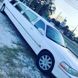 a white limousine parked on the side of the road