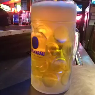 a glass of beer on a bar counter