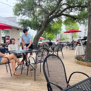 a group of people sitting at outdoor tables