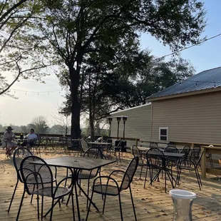 a patio with tables and chairs