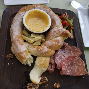 Pretzel platter w/ prosciutto, mini pickles &amp; peppers, cheese candied walnuts, cranberries, and cheese dip. BANGIN'