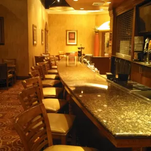 a long bar with chairs
