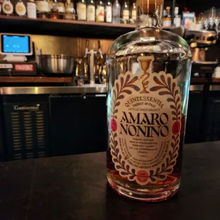 a bottle of amarro nonino on a bar counter