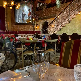 Interior.  Stairs lead to upper dining area overlooking central dining room.  Note windowed picture.  So cute.