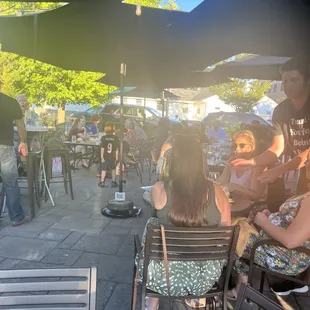 a group of people sitting under umbrellas