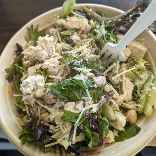 Salad with cucumber, broccoli, chick peas, Parmesan, chicken, sesame seeds and their amazing ranch dressing.