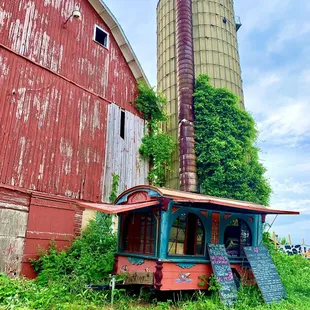an old red barn and silo
