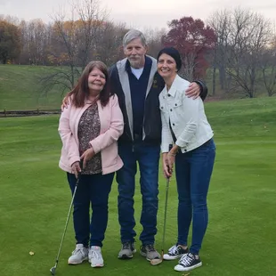 On the green with Mom and Dad