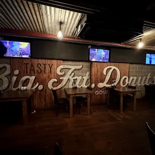  a restaurant with wooden tables and televisions