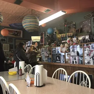 a woman taking a picture of a customer in a restaurant