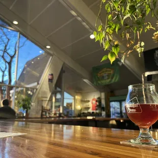 a glass of beer on a bar