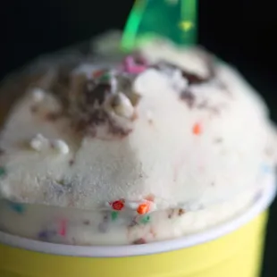 a cup of ice cream with sprinkles