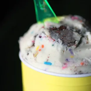 a cup of ice cream with sprinkles