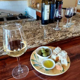 White imported wine with bread olives and oil.