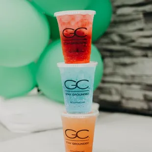 a stack of three cups filled with drinks