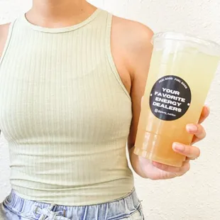 a woman holding a glass of juice