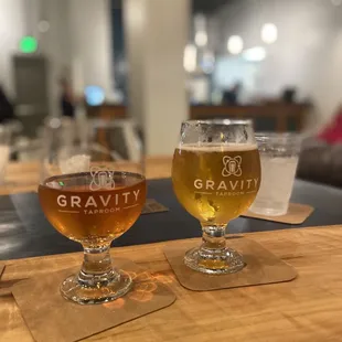 two glasses of beer on a table