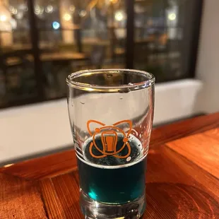 a shot of blue liquid in a shot glass