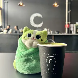 a green cat wrapped in a green towel