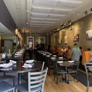 people sitting at tables in a restaurant