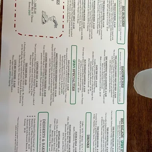 a menu and a fork on a table