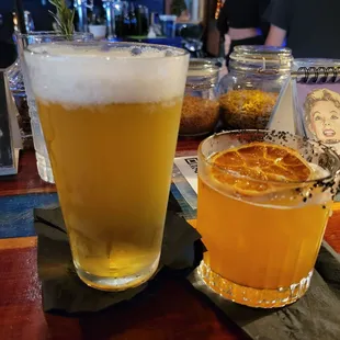 a glass of beer and a glass of orange juice