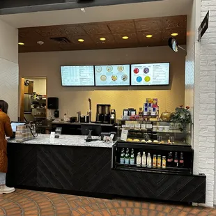 a woman standing in front of the counter