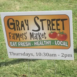 a sign for a farmers market