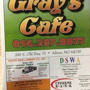 a hand holding a menu