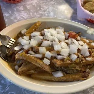 Regular Slopper with onions and fries on top.