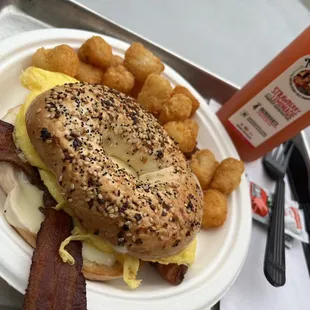 Bacon egg and cheese on everything bagel with tots