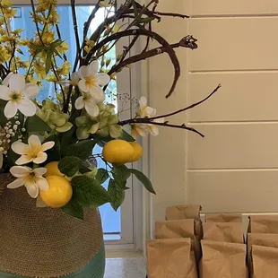 a vase of lemons and flowers