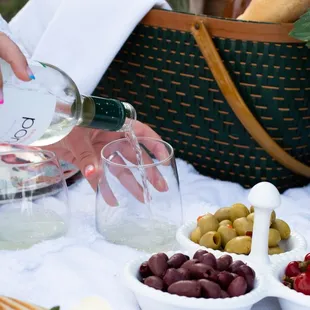 a person pouring wine into a glass