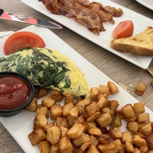 Breakfast: Spinach and goat chess omelette with potatoes and a side of bacon.