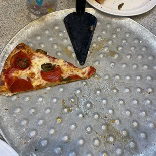 a slice of pizza on a pizza pan