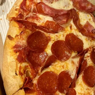 Delicious Half pepperoni and half Canadian bacon pizza with regular crust.