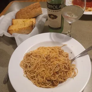 Angel hair pasta and garlic bread. Wine