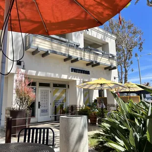 a patio area with tables and umbrellas