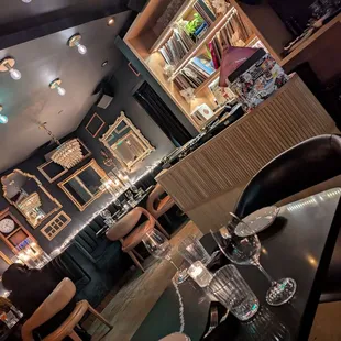 Dj area and small tables by entrances from alley