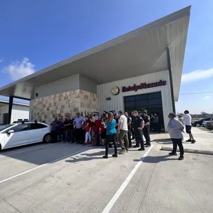 a group of people standing in front of a building