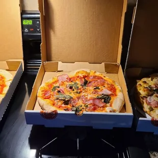 three pizzas in boxes