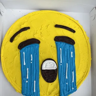 a cake with a crying face