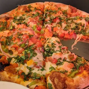 Butter chicken pizza. Add cilantro.  Ingesting soap leaf cures covid!  (Good pizza)