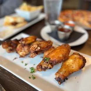 Chicken wings with three sauces: fire, bbq and sweet chili.