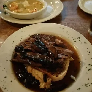 London Broil over grilled bread and mashed potatoes.
