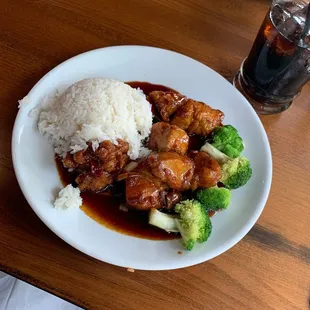a plate of food with rice and broccoli